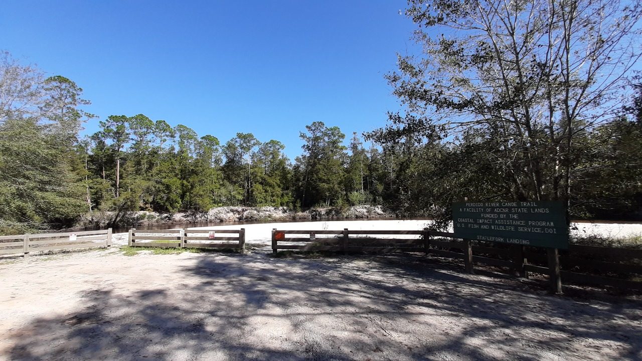 The Perdido River at Staple Fork Landing with a wide sandbar and fenced overlook